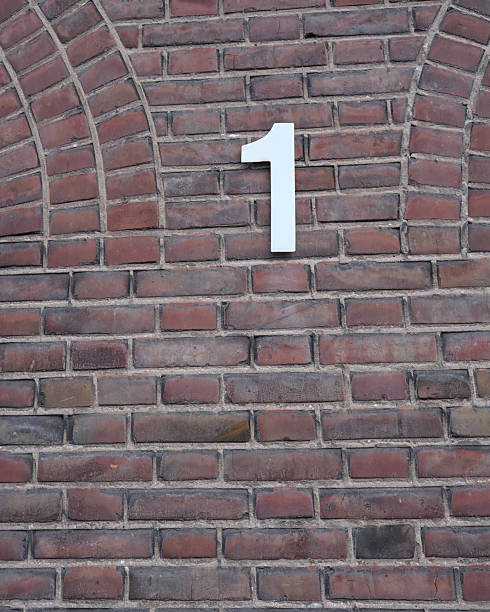 istock Unique wall with brick pattern featuring a bold white number one on display in an urban environment 2253136155