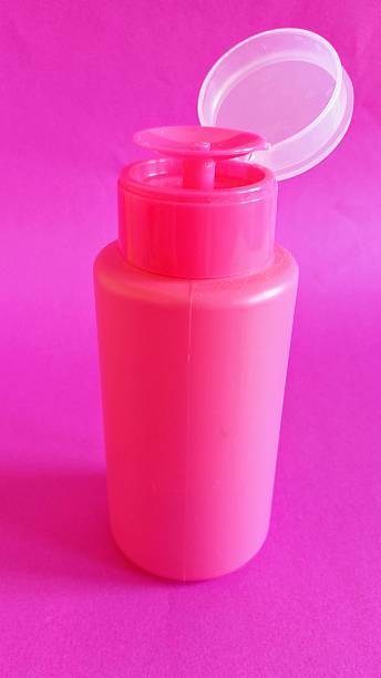 istock Pink plastic bottle on pink background. Acetone bottle. 2253136711