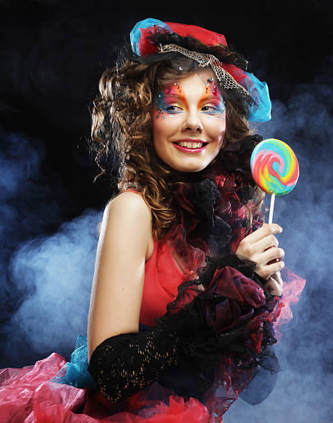istock Girl with with creative make-up holds lollipop. 2253138950
