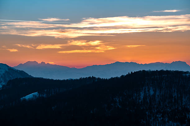 istock Colorful sunset painting mountain silhouettes and cloud layers 2253141767