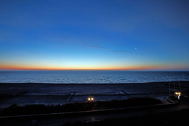 A tranquil blue hour sunset over the Baltic Sea with soft colors and calm water at the horizon.