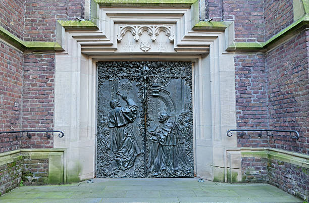 Kevelaer-Duitsland /18 December-2025: Side entrance of the Maria Basilica.  Bronze Door with images and decorated with biblical scenes. Also the history of the pilgrimage site.