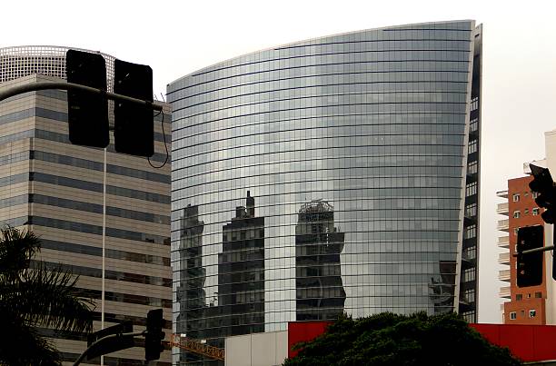 istock Modern glass building reflecting other buildings 2253149643