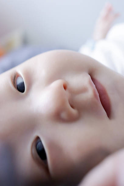 Close up portrait of a child with Down Syndrome. Authentic, real people.