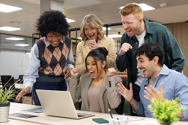 istock Diverse business team celebrating success at office 2253152346