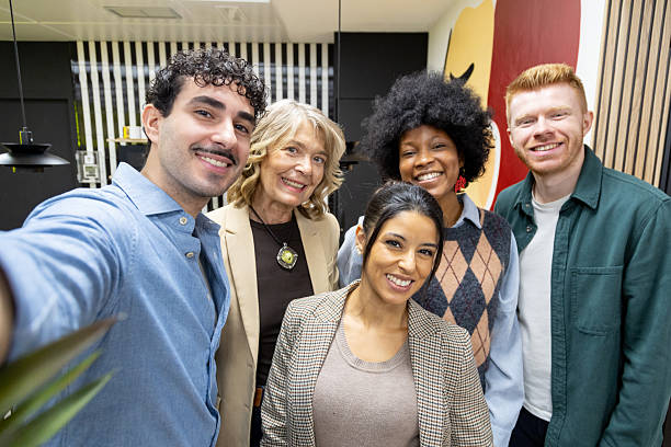 istock Diverse team taking a happy selfie in office 2253152410