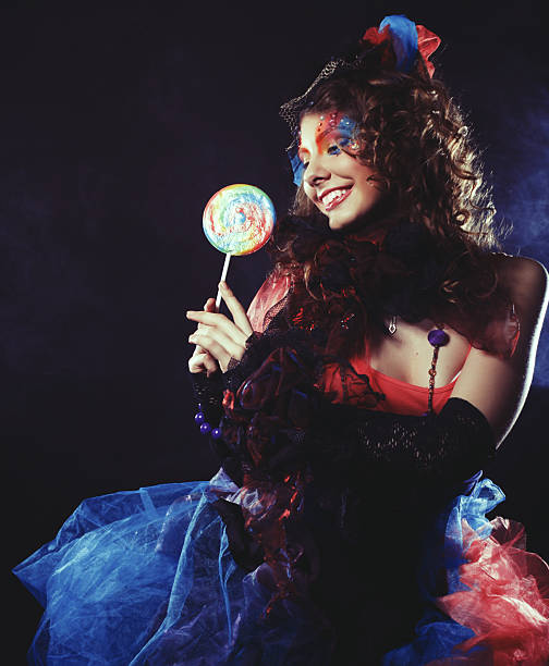 istock Girl with with creative make-up holds lollipop. Doll style. 2253155285