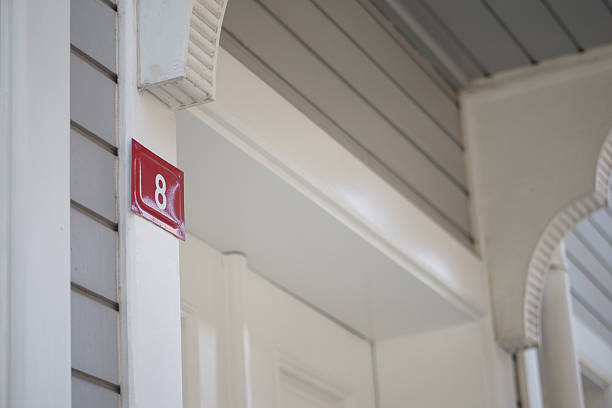 Iron lanterns closed to white door on the wall. Outdoor entrance interior design