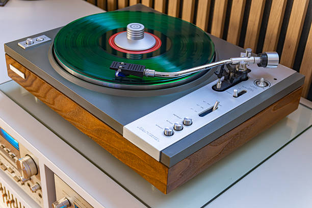 istock Green vinyl record spinning on vintage turntable 2253156555