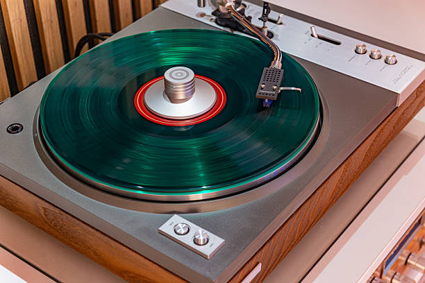 istock Green vinyl record spinning on vintage turntable 2253156559