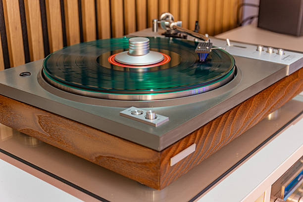 istock Green vinyl record spinning on vintage turntable 2253156562