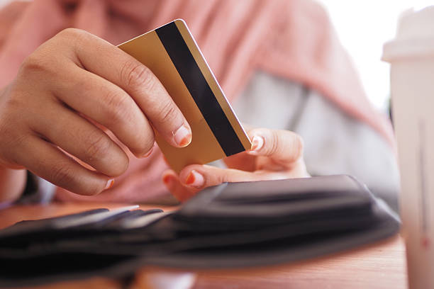 istock Paying at a cafe with a credit card in hand 2253156580