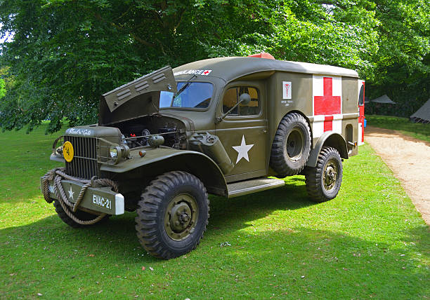 Silsoe, Bedfordshire, England - May 28, 2017:  Second World War  Ambulance parked in front of trees.