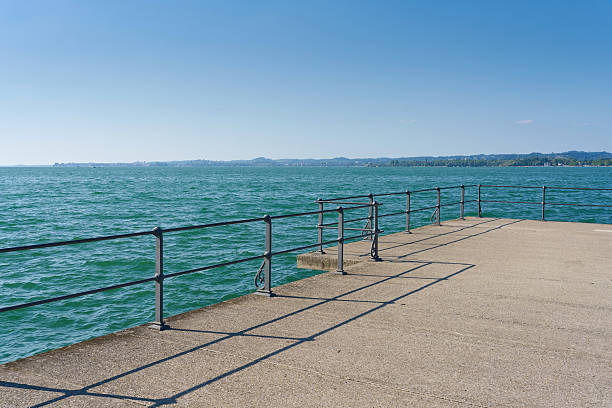 Waterfront promenade with railing on the small pier, kleine Seemole in the port of Bregenz, Austria, on Lake Constance