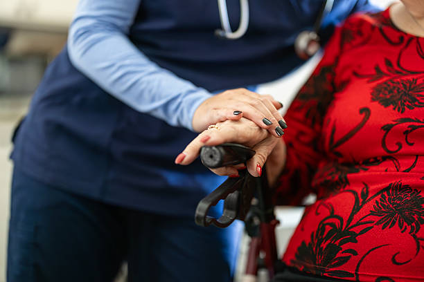 istock A Home Health Aid with Patient holding hands 2253160289