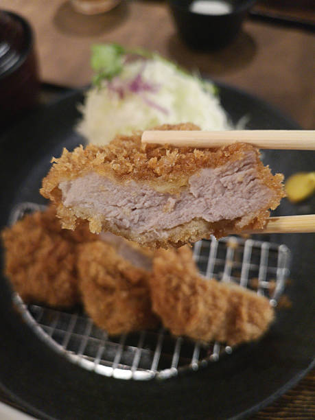 Japanese Tonkatsu Pork Cutlet Held with Chopsticks