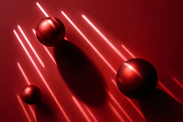 Abstract composition of three red matte spheres with geometric light lines and shadows. Minimalist background for beauty or luxury brand conceptual design