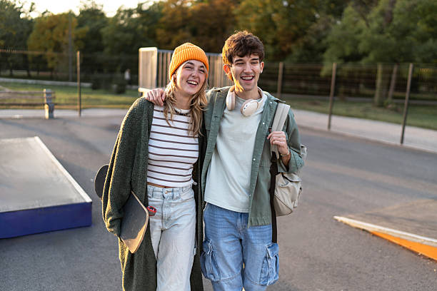 istock Happy young friends walking at skatepark 2253167501