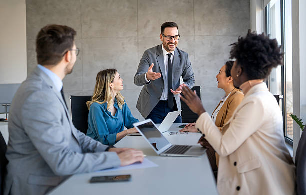 istock Happy multiethnic businesspeople laughing while collaborating on a new project in an office. 2253169815