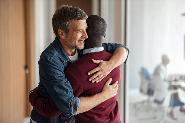 istock Warm Hug Between Friends At Office Break Room Emphasizing Friendship and Support 2253171358