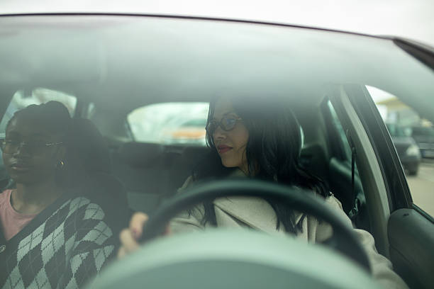 istock Two female friends sitting in car seen through windshield 2253171734