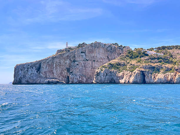 Tall cliff with lighthouse at Cape Sant Antoni near Javea, Spain.