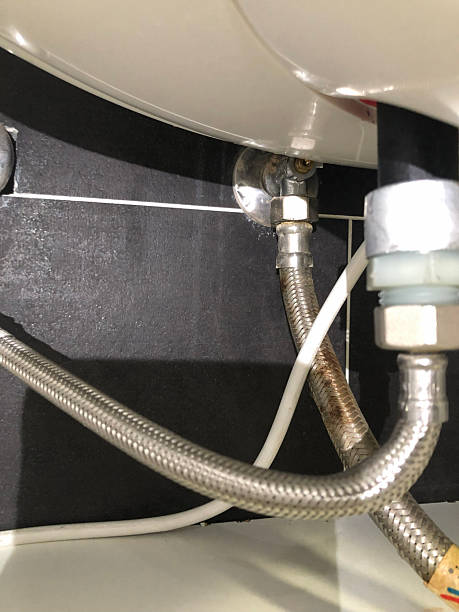 istock Water heater pipes close-up under sink installation 2253171891
