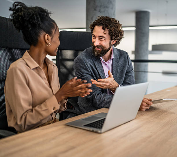 istock Business people collaborating on laptop in modern office 2253174558