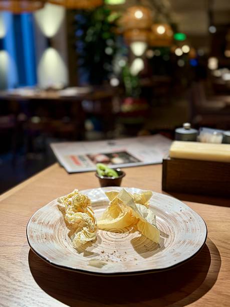 istock Plate with butter and cabbage, rustic ceramic dish on wooden table under warm ambient light, scattered crumbs and butter shavings, intimate bistro vibe, quiet after meal moment 2253176061