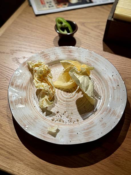 istock Plate with butter and cabbage, rustic ceramic dish on wooden table under warm ambient light, scattered crumbs and butter shavings, intimate bistro vibe, quiet after meal moment 2253176766