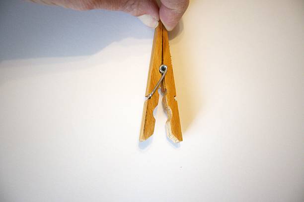 Clothespins attached to a utility rope against a blurred background, offering ample copy space.
