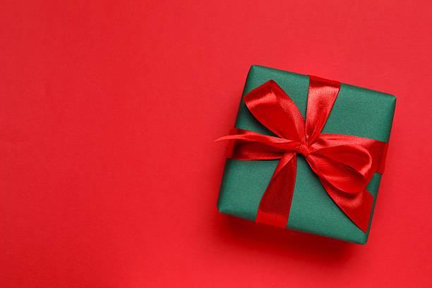 istock Top view of Christmas gift box on red background 2253177083