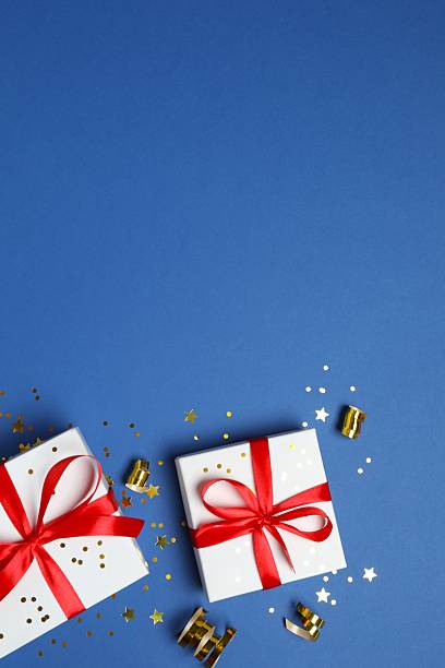istock Beautiful festive gift boxes on color background 2253177172