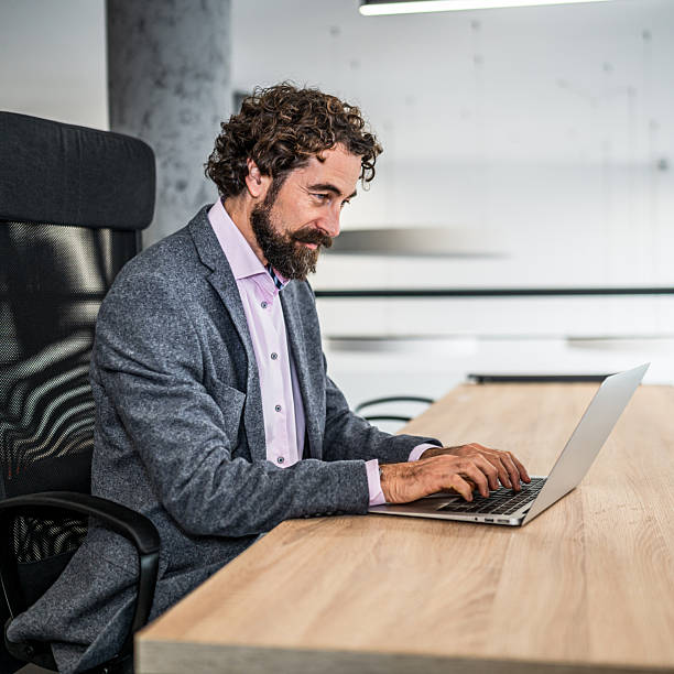 istock Professional man working on laptop in modern office 2253177491