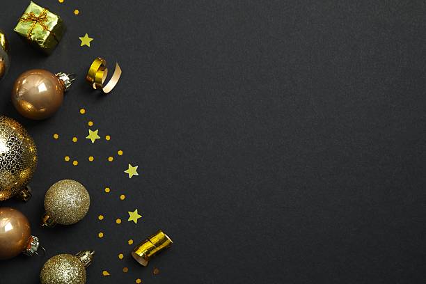 istock Top view of Christmas decorations, confetti on black background 2253177762