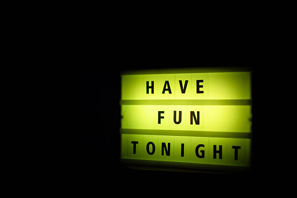 A light display of yellow color written on it ''have fun tonight''. Motivation concept.