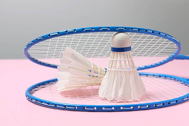 istock Badminton rackets and white badminton shuttlecocks on color background 2253178618