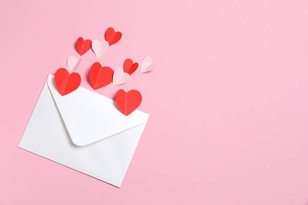 istock White paper envelope with Valentines hearts on pink background. Flat lay, top view. Romantic love letter for Valentine's day concept. 2253178929