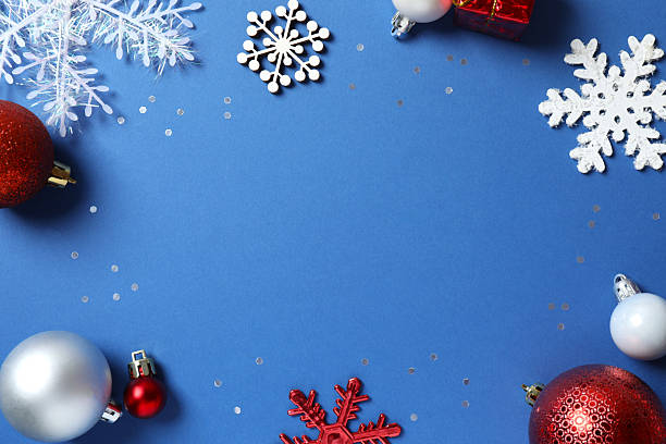 istock Top view of Christmas decorations and confetti on blue background 2253179209
