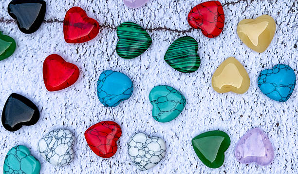 istock Colorful heart-shaped stones on white textured background 2253179650