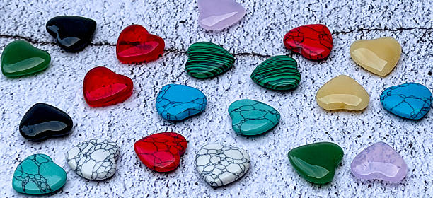 istock Colorful heart-shaped stones on white textured background 2253179651