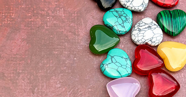 istock Colorful Heart Shaped Gemstones On Textured Background With Copy Space 2253179681