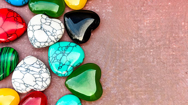 istock Colorful Heart Shaped Gemstones On Textured Background With Copy Space 2253179687