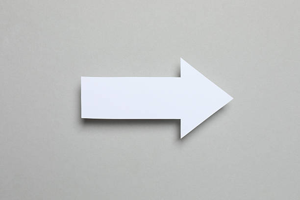 istock Paper arrow on color background, top view 2253180507