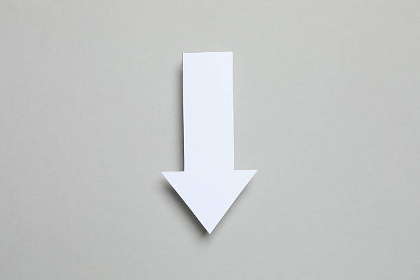 Paper arrow on color background, top view