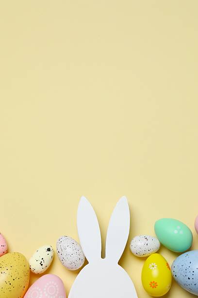 istock Happy Easter. Colorful eggs and bunny ears on color background, space for text or advertising 2253180721