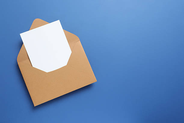 istock Top view photo with paper card and envelope on blue background with empty space 2253181542
