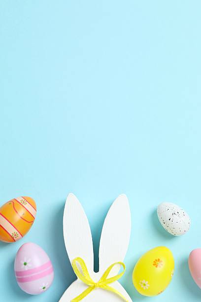 istock Happy Easter. Colorful eggs, bunny ears on a pastel color background, space for text or advertising 2253181579