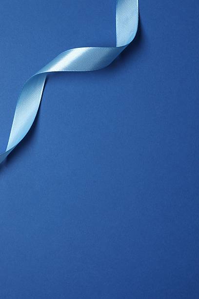 istock Beautiful blue silk ribbon on a color background 2253182896
