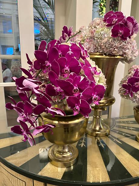 istock Purple Orichids & Pastel Hydrangeas in Brass Vases on a Striped Table 2253183068